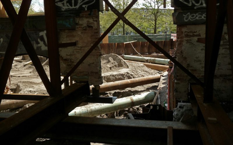 a view of a construction site through a hole in the wall