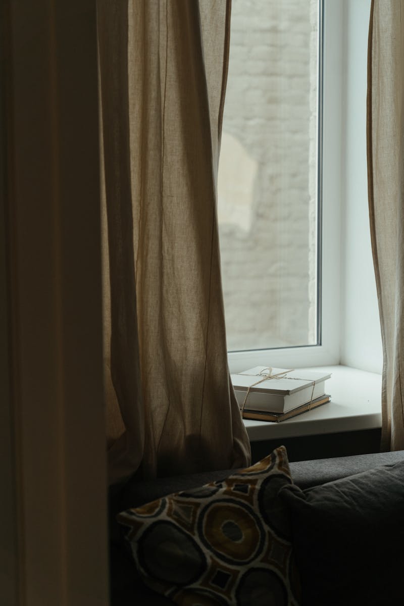 Warm and inviting indoor scene with books on a windowsill, perfect for relaxation.