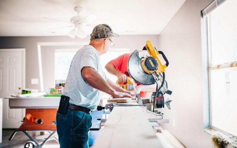 man standing infront of miter saw