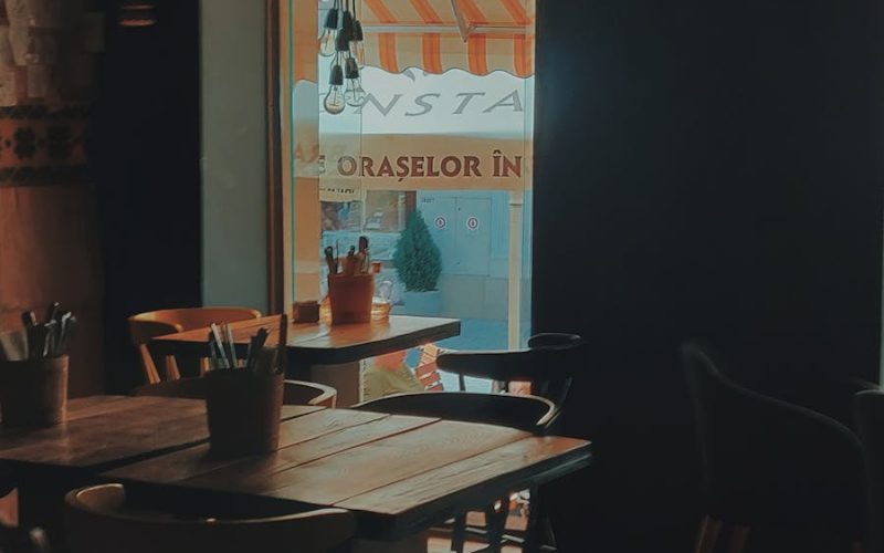 Warm and inviting dining space with wooden furniture and ambient lighting, enhancing a relaxing atmosphere.