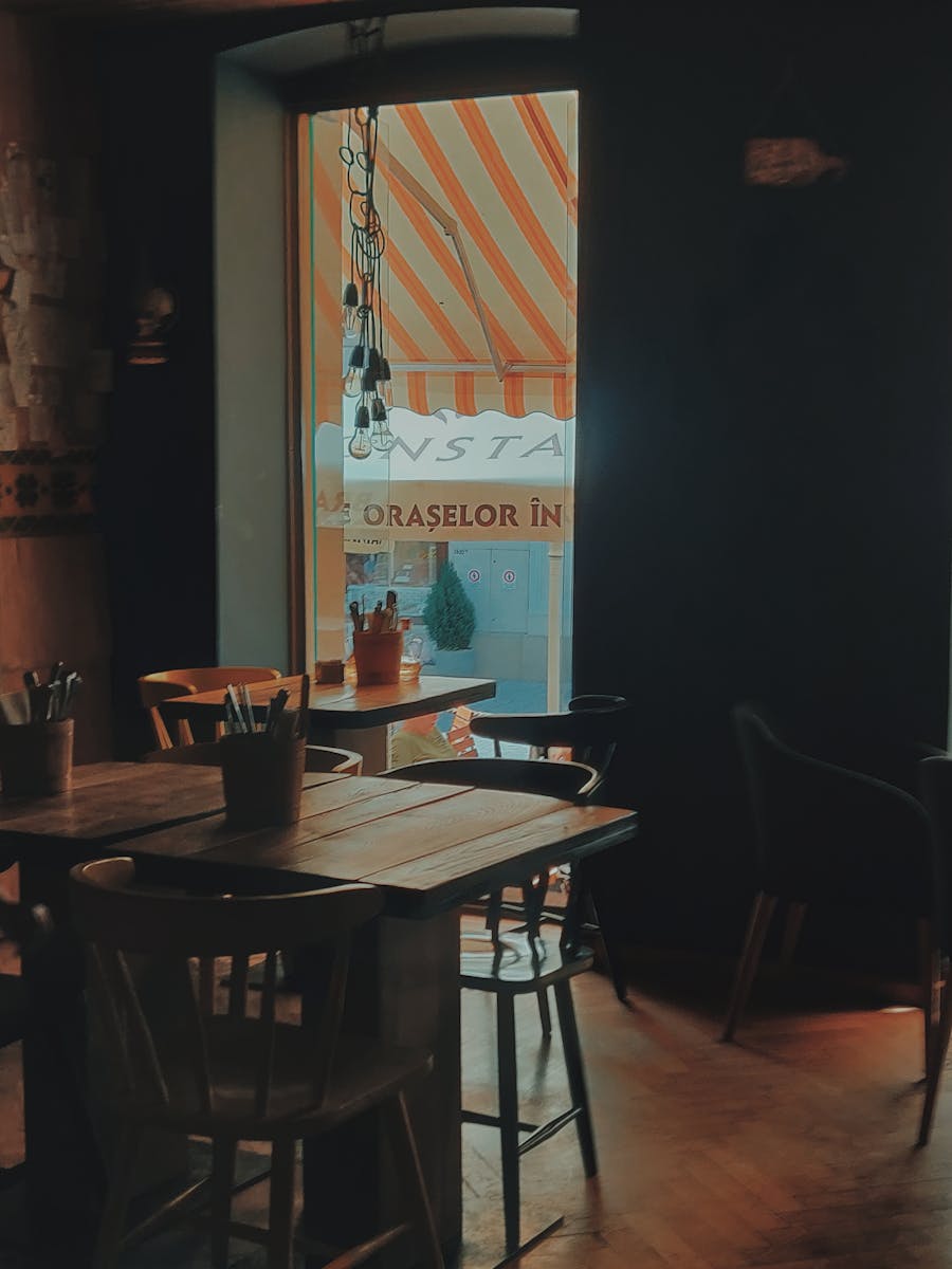 Warm and inviting dining space with wooden furniture and ambient lighting, enhancing a relaxing atmosphere.