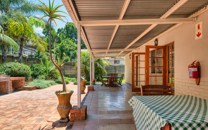 Inviting patio in Pretoria, South Africa with lush greenery, ideal for relaxing outdoors.
